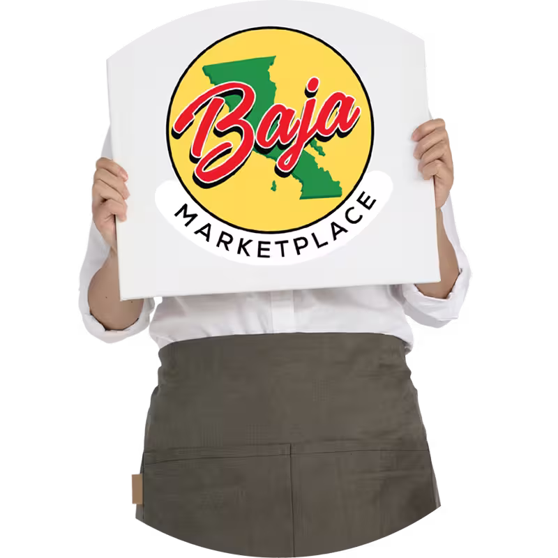 A person holds a sign with a Baja Marketplace logo