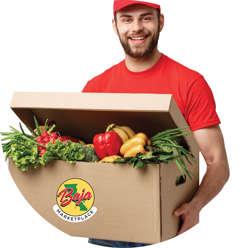 Person holding a box of fresh vegetables with a Baja Marketplace logo
